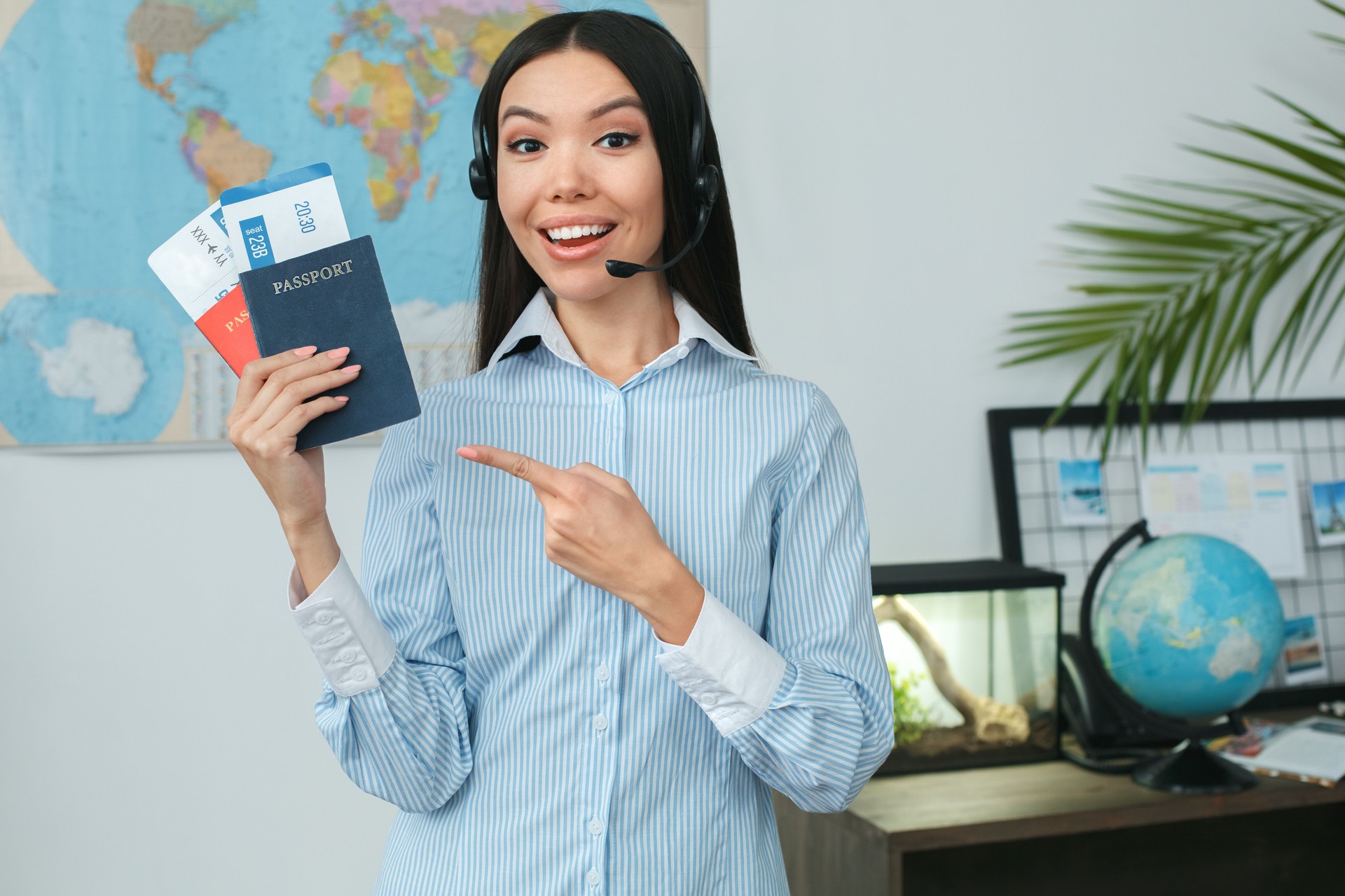 Young female travel agent consultant in tour agency showing documents
